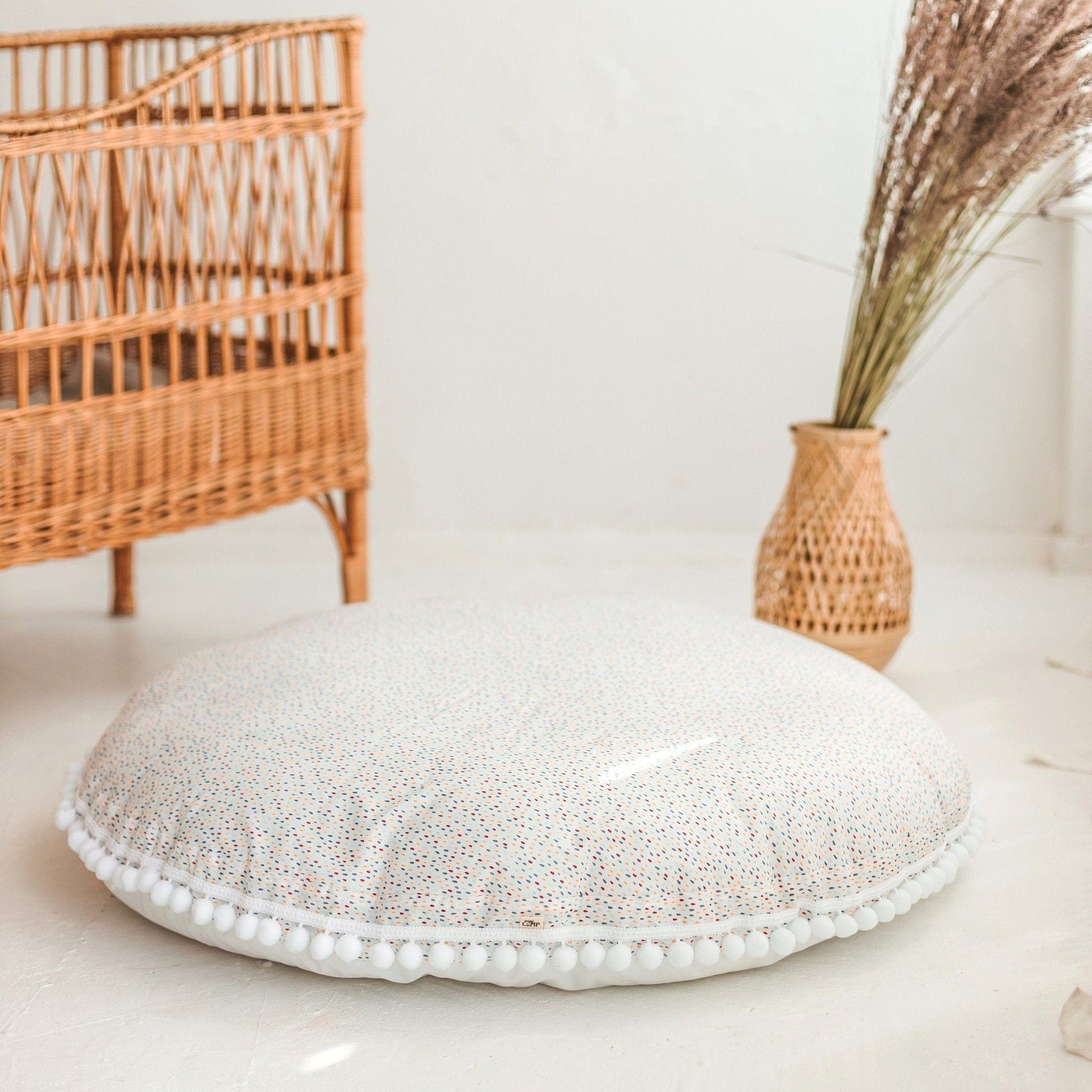 close up of MINICAMP Big Floor Cushion With Pompoms in Colour Drops on White