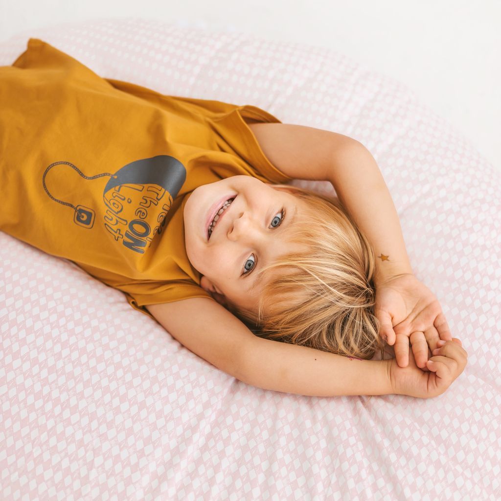 smiling child lying on back on MINICAMP Big Floor Cushion Rhombus Diamond - Pink