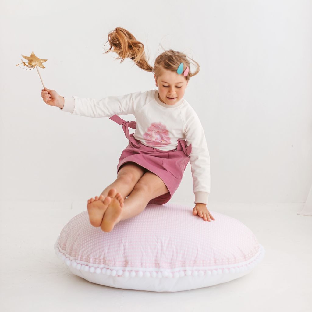 girl holding wand whilst jumping onto MINICAMP Big Floor Cushion Rhombus Diamond - Pink
