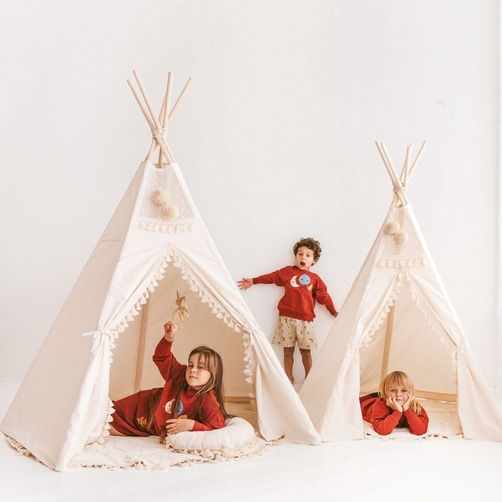 three children in MINICAMP Extra Large Indoor Teepee Tents With Tassels Decor in Boho Style