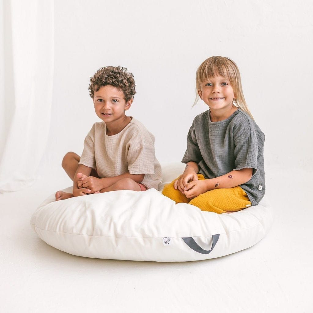 boy and girl sitting on MINICAMP Lounger Floor Pillow With Handle