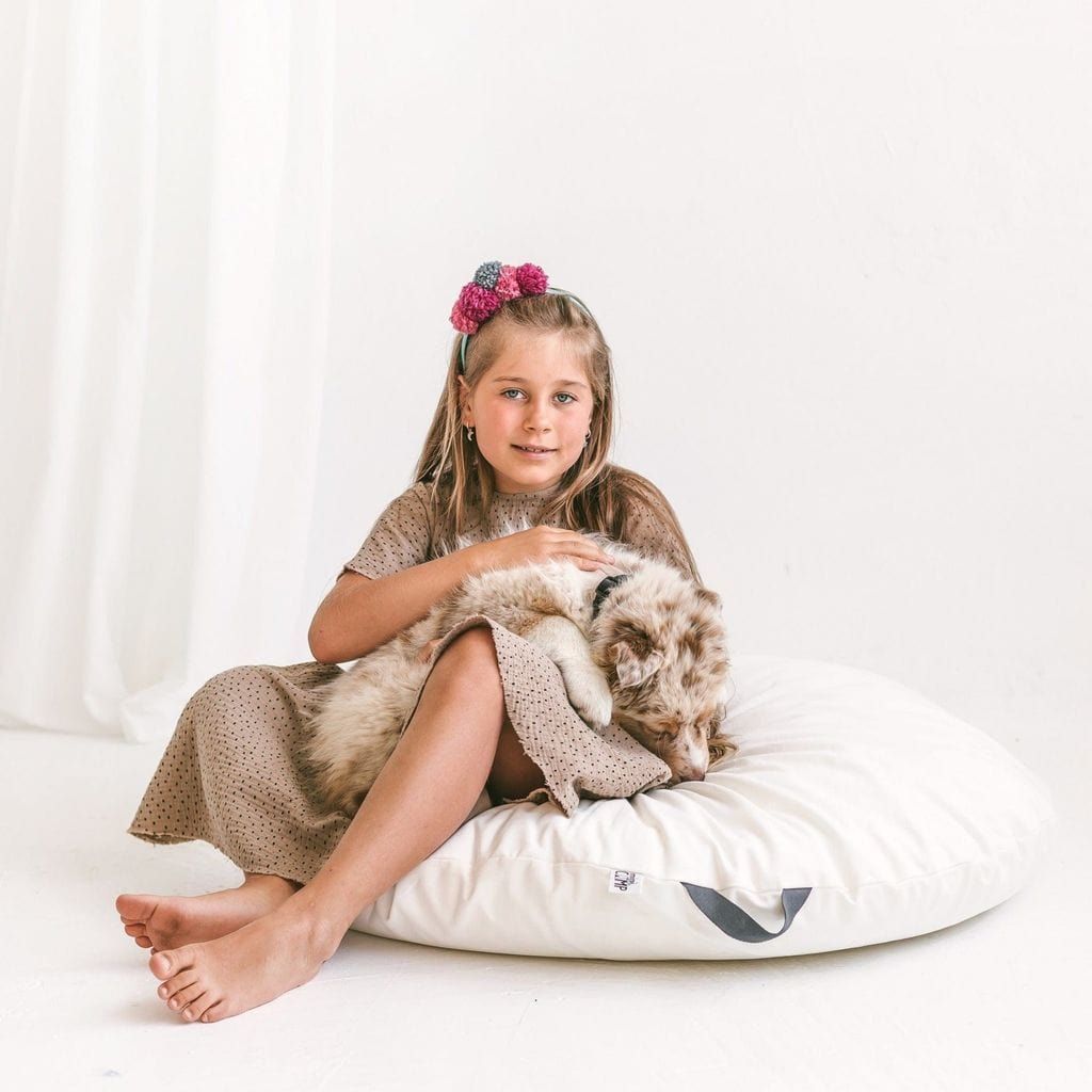girl with dog sitting on MINICAMP Lounger Floor Pillow With Handle