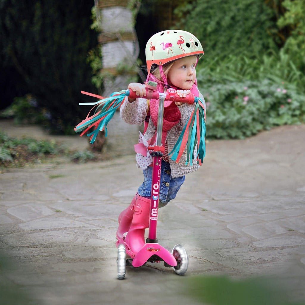 girl riding Micro Scooter Mini Deluxe LED - Pink