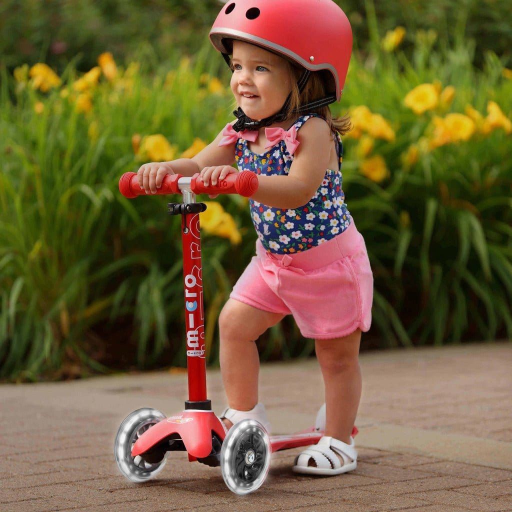girl riding Micro Scooter Mini Deluxe LED - Red