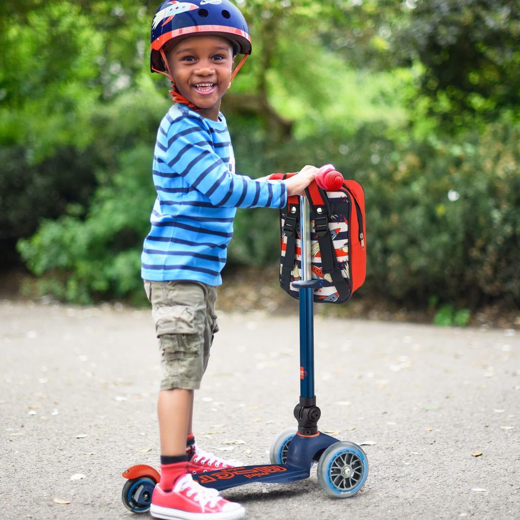 smiling boy standing with Micro Scooter Mini Foldable - LED Navy 