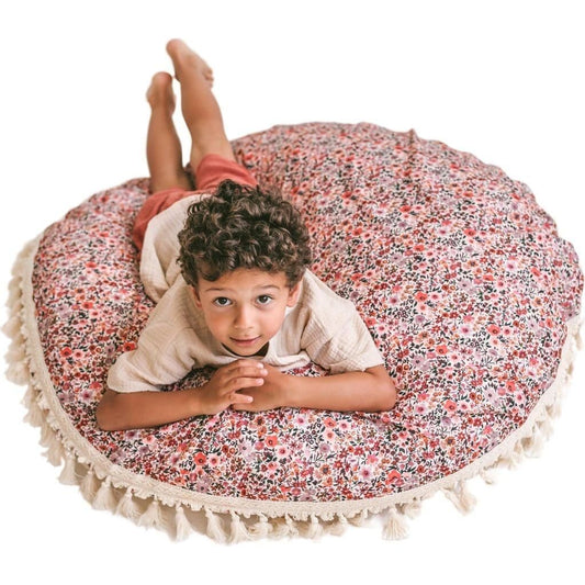 boy lying on MINICAMP Big Floor Cushion With Flower Pattern and looking up