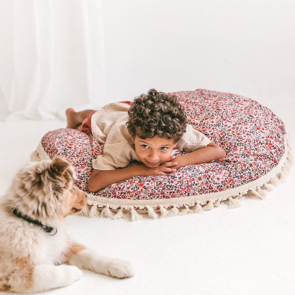 boy lying on MINICAMP Big Floor Cushion With Flower Pattern with dog