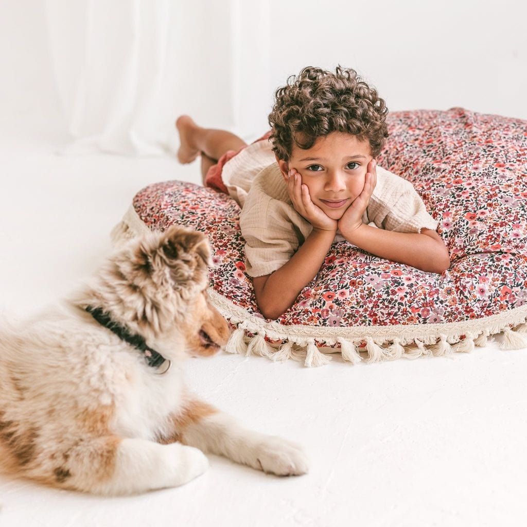 boy lyiing on MINICAMP Big Floor Cushion With Flower Pattern with dog