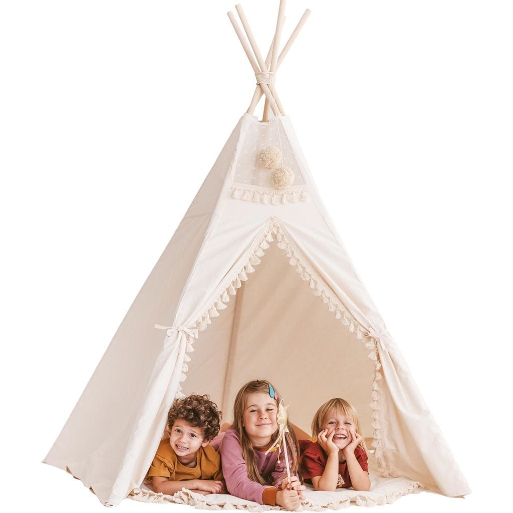 three children lying in MINICAMP Extra Large Indoor Teepee Tent With Tassels Decor in Boho Style