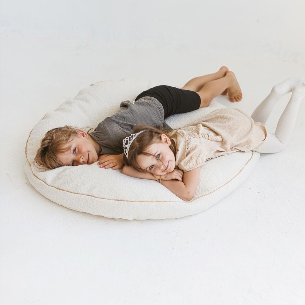 boy and girl lying on MINICAMP Boucle Fabric Kids Floor Cushion in Ecru 
