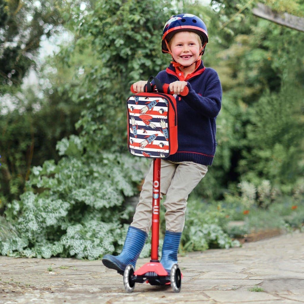 boy riding Micro Scooter Maxi Deluxe LED - Red on path