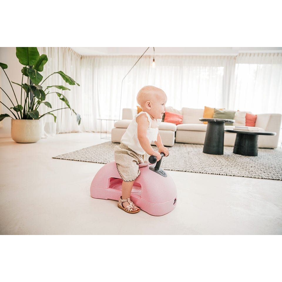 baby sitting on Scoot and Ride My First 3-in-1 Baby Walker & Ride on - Rose from side