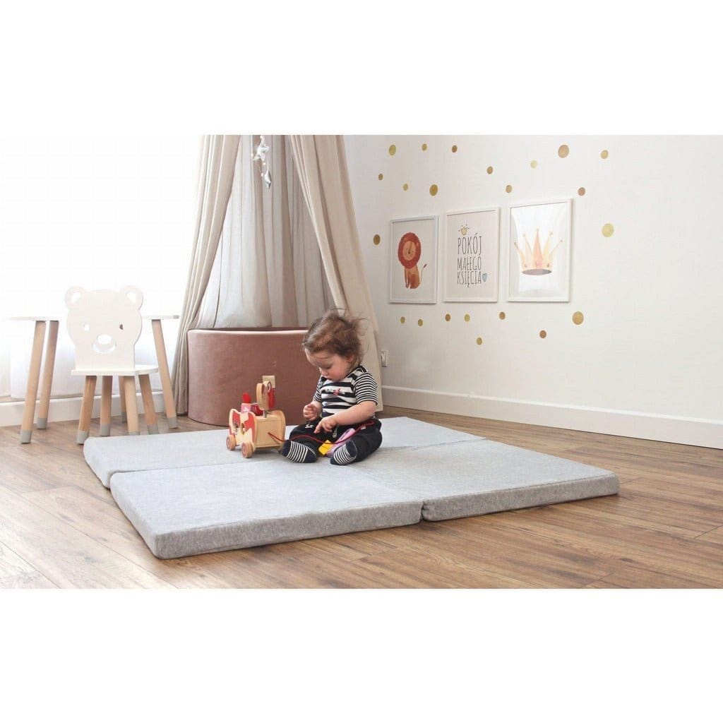 child sitting on Meow Baby Square Foldable Baby Play Mat in bedroom