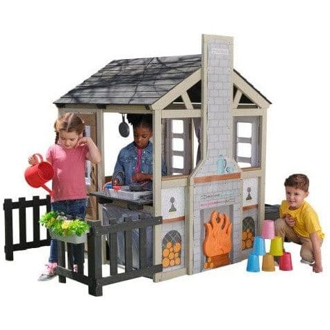 children playing with KidKraft Cozy Hearth Cabin Playhouse