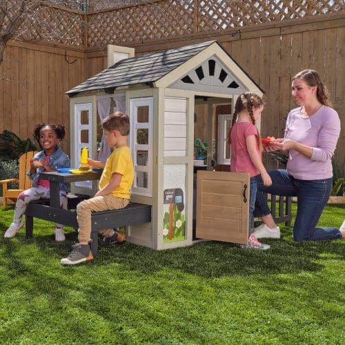 woman and children playing in KidKraft Cozy Hearth Cabin Playhouse