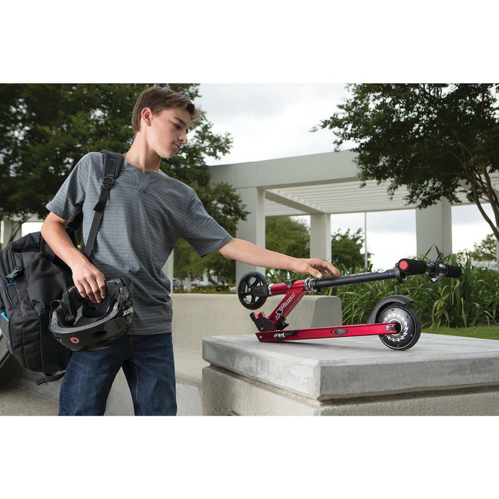 boy picking up folded Razor Power A2 Scooter 22 Volt Scooter