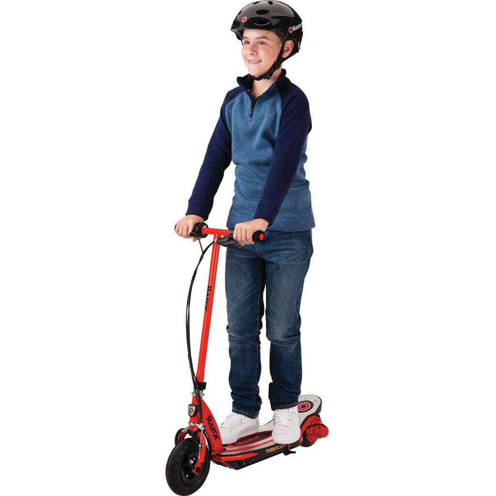 boy standing on Razor Power Core E100s 24 Volt Scooter - Red