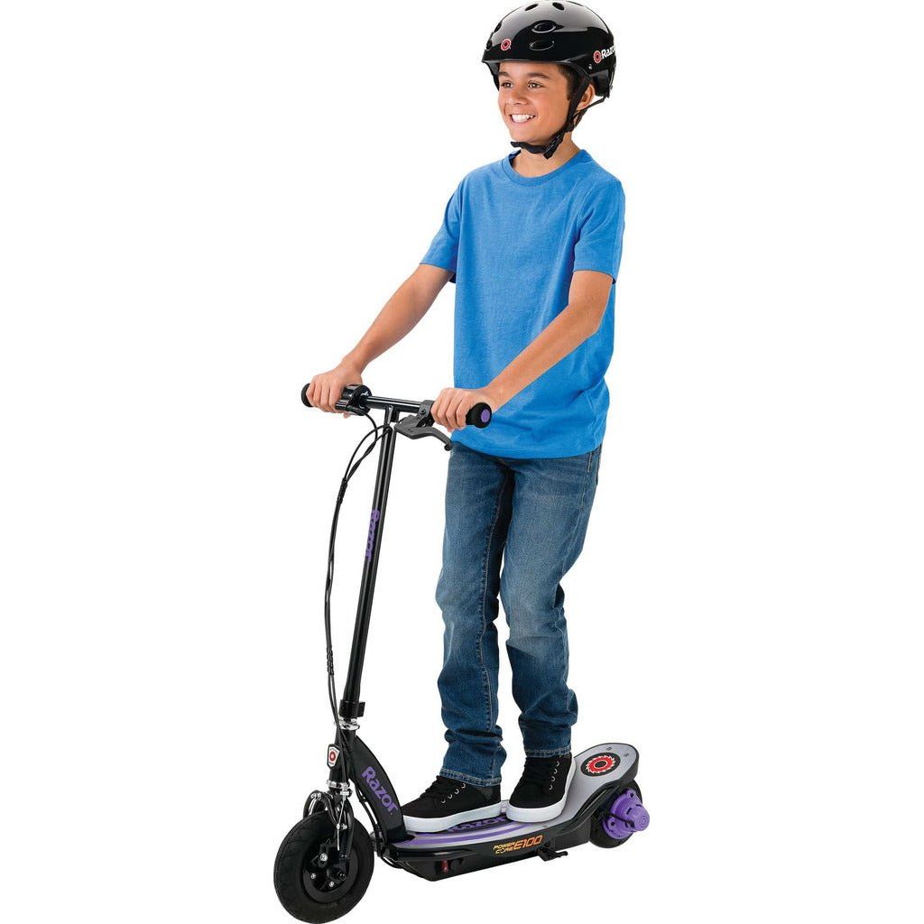 boy in helmet riding Razor Power Core E100 24 Volt Scooter - Purple