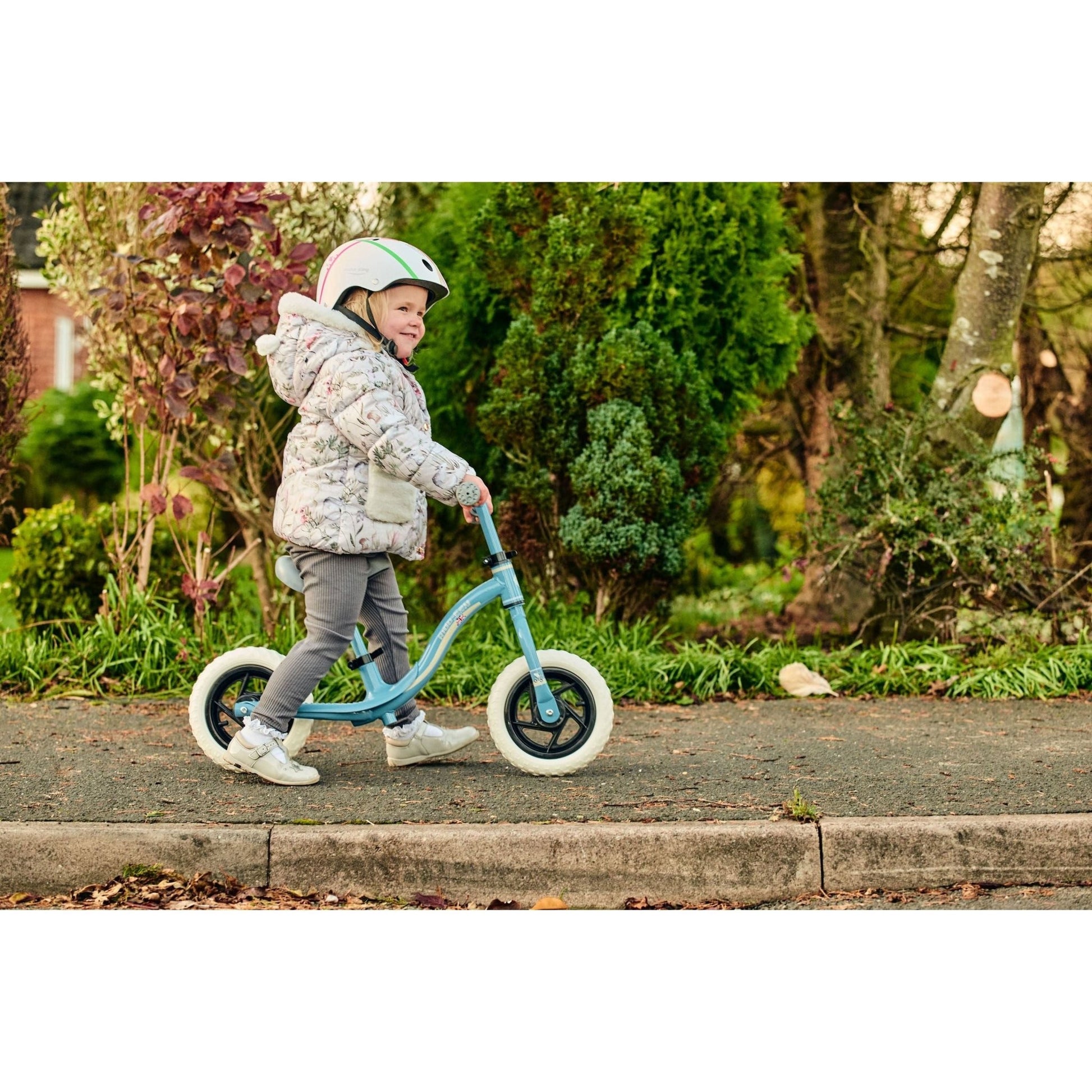 little girl on pavement riding Ride-Ezy Go Balance Bike - Blue & Silver