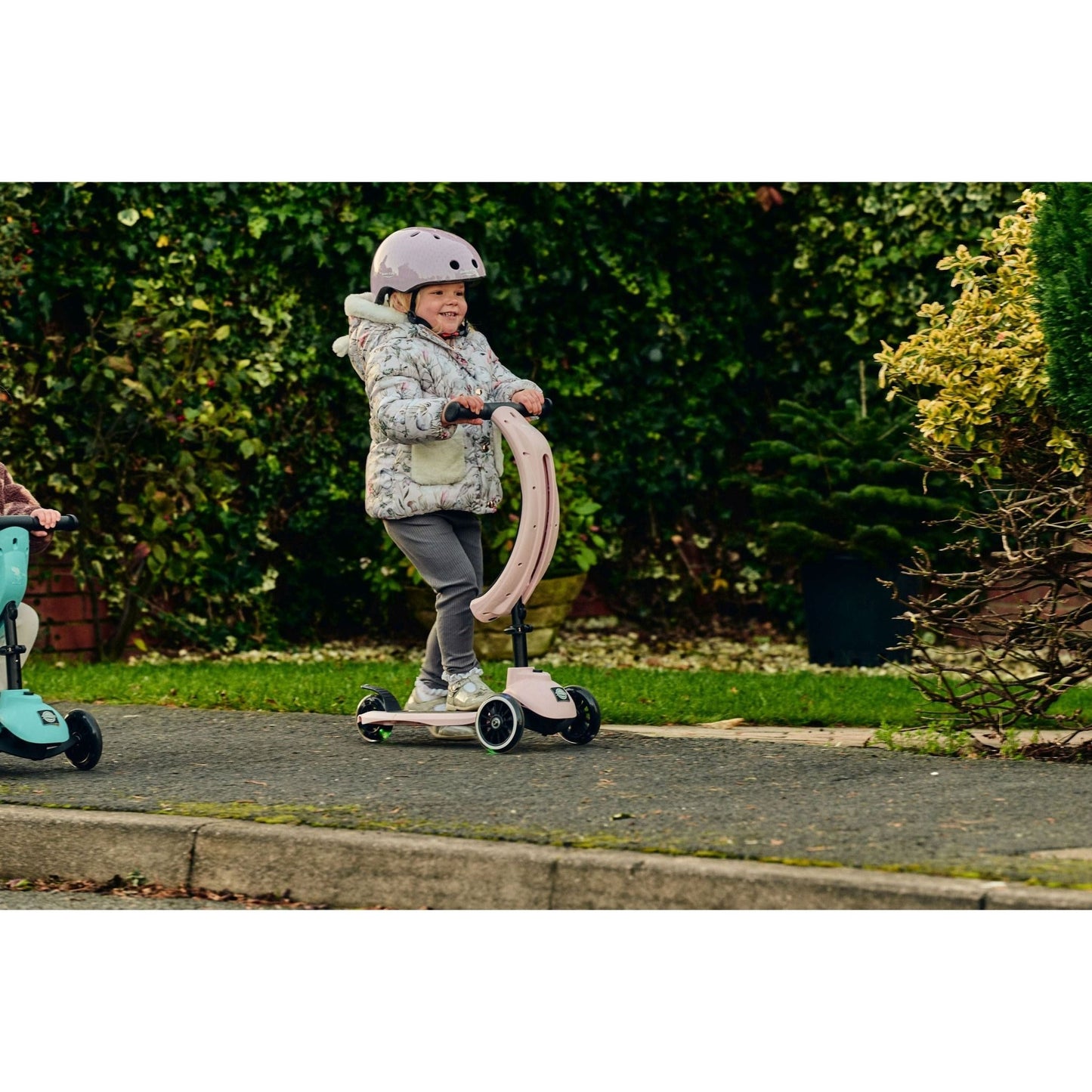 girl riding Ride-Ezy scooter and wearing Hector 48-53cms Kids Helmet - Blossom