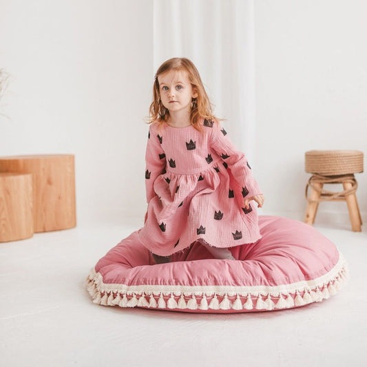 girl kneeling on MINICAMP Large Floor Cushion With Tassels in Rose