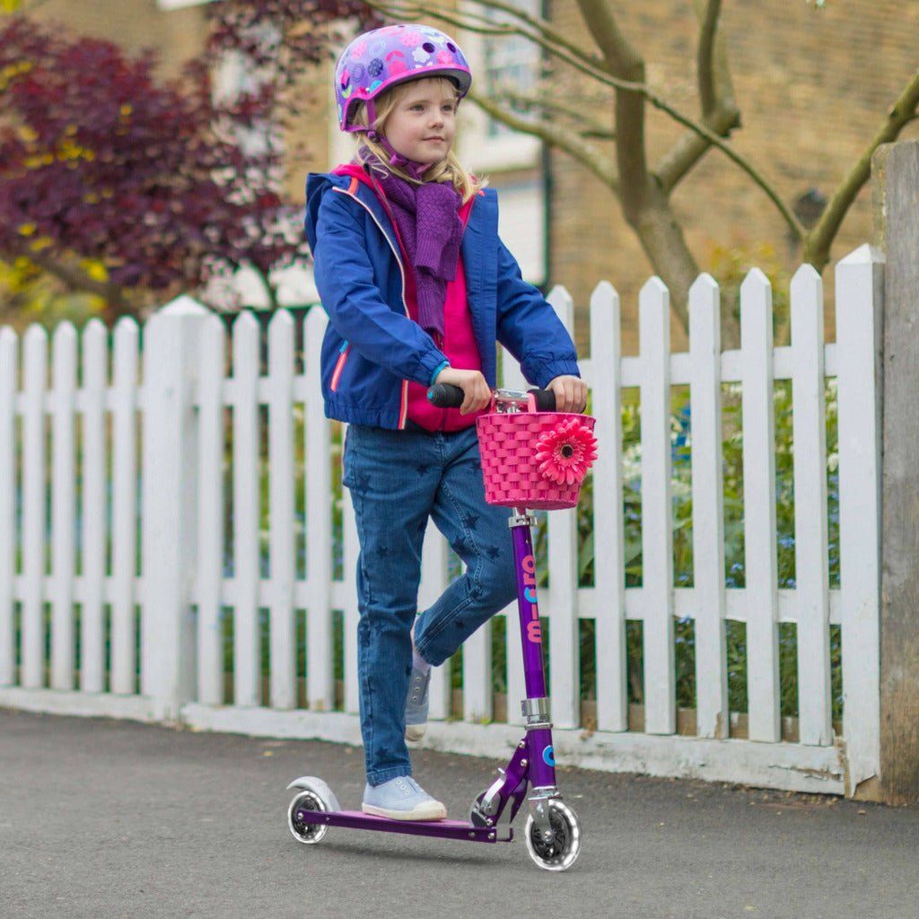 girl riding Micro Scooter Sprite LED - Purple on pavement