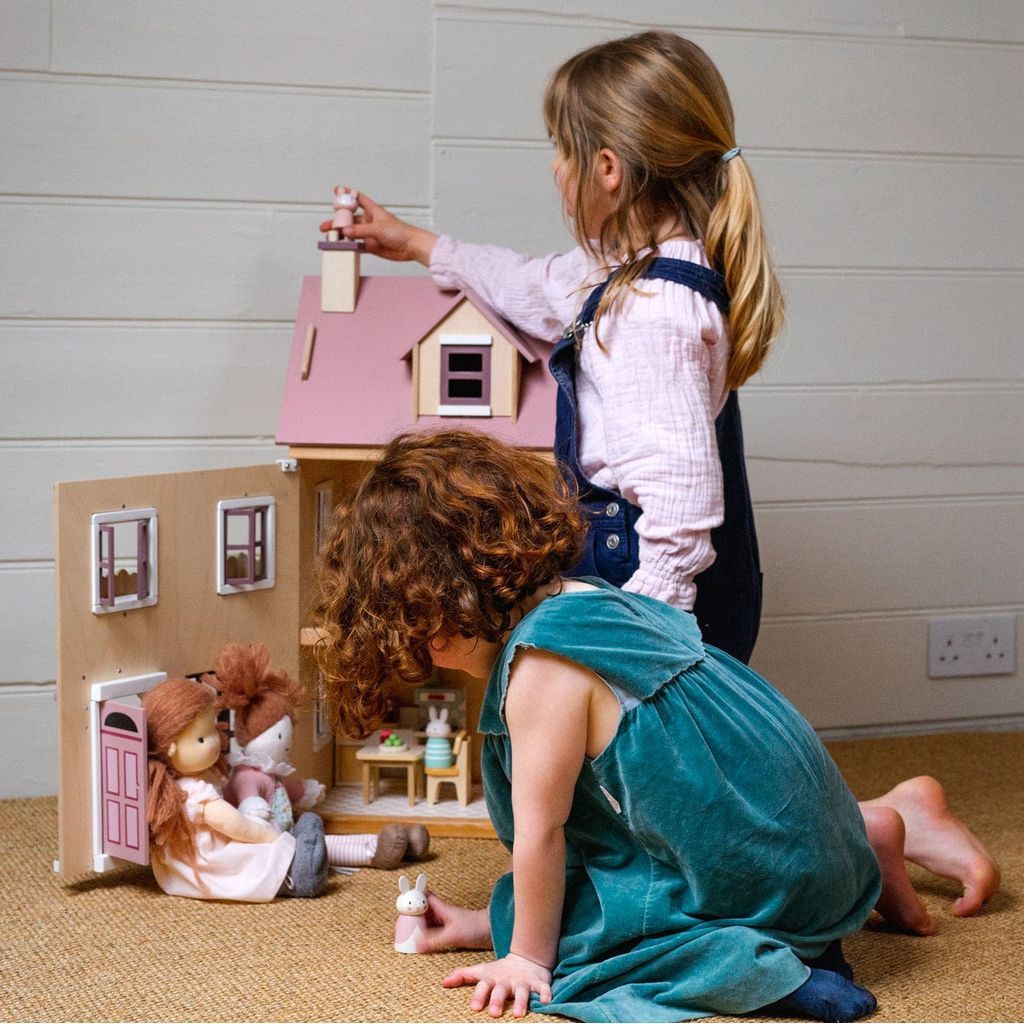 girls playing with Tender Leaf Wooden Doll House Foxtail Villa + Furniture