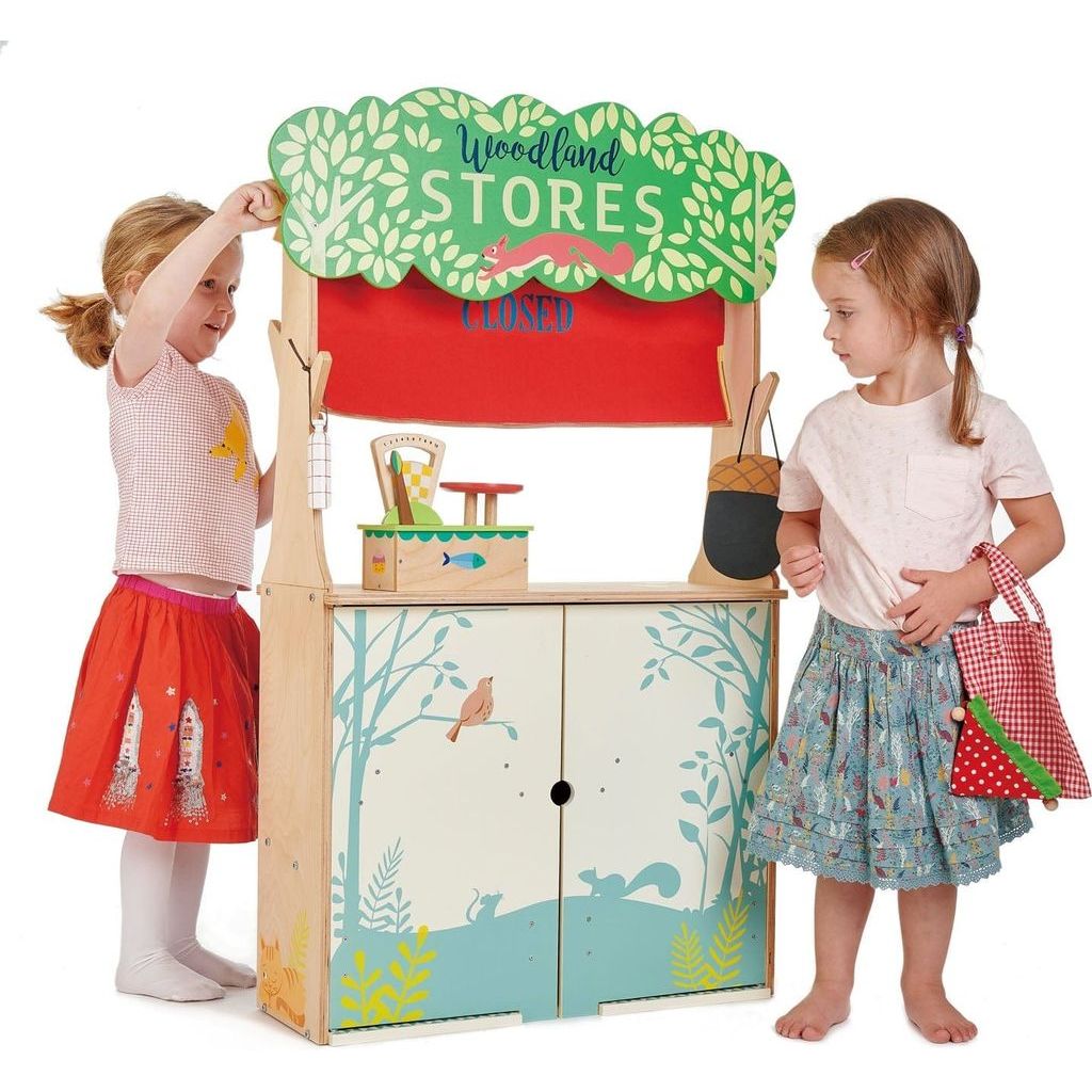 2 girld playing with Tender Leaf Woodland Stores & Theatre wooden toy 
