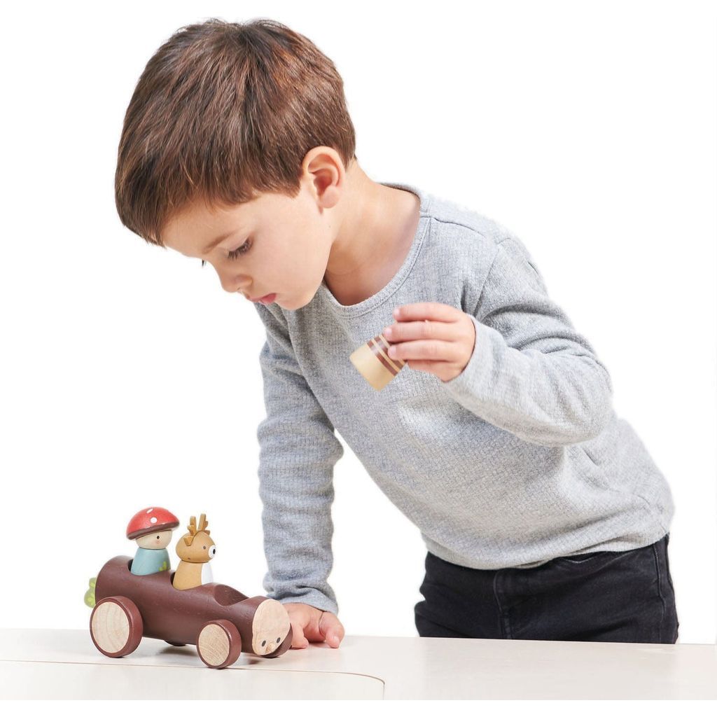 boy playing with Tender Leaf Timber Taxi Wooden Toy