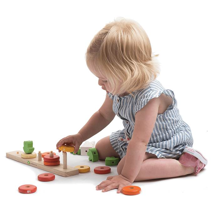 giel playing with Tender Leaf Counting Carrots Wooden Counting Game
