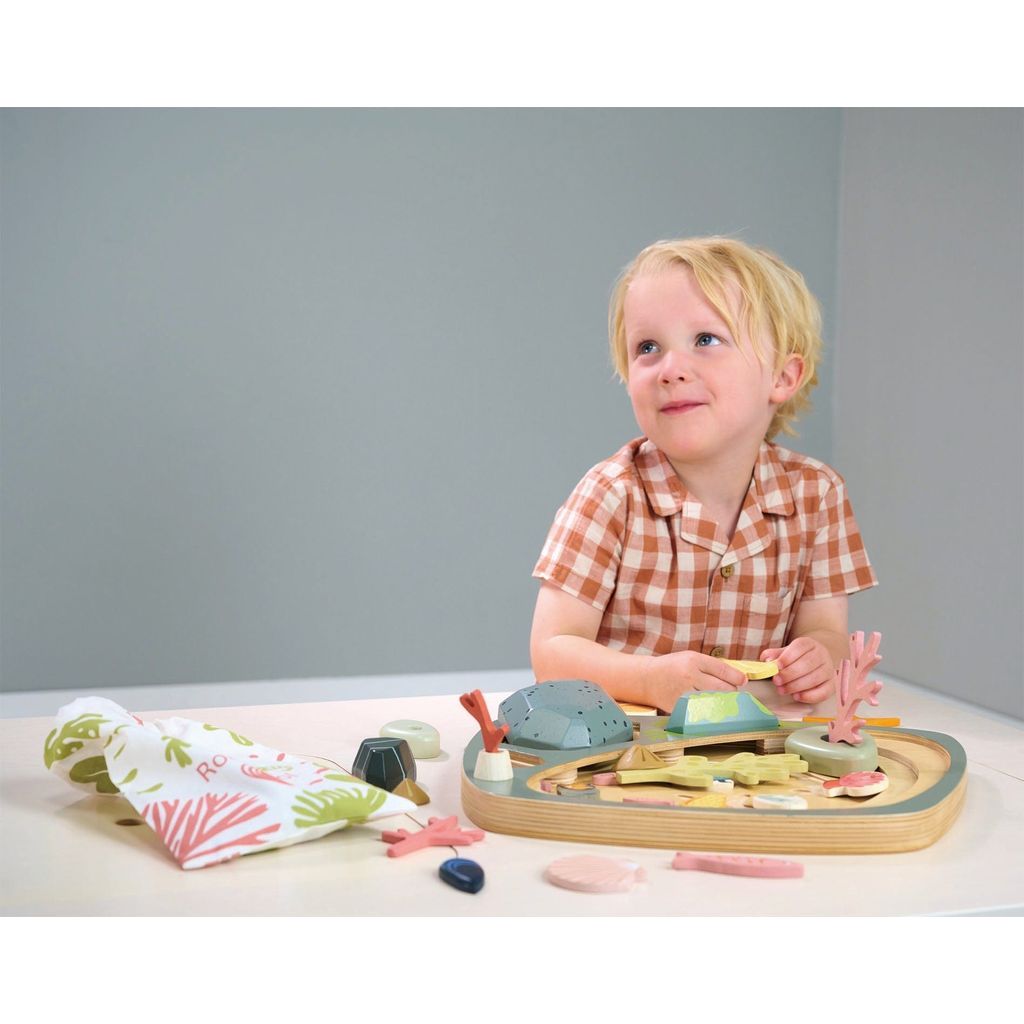 boy playing with Tender Leaf Toys My Little Rock Pool Wooden Toy