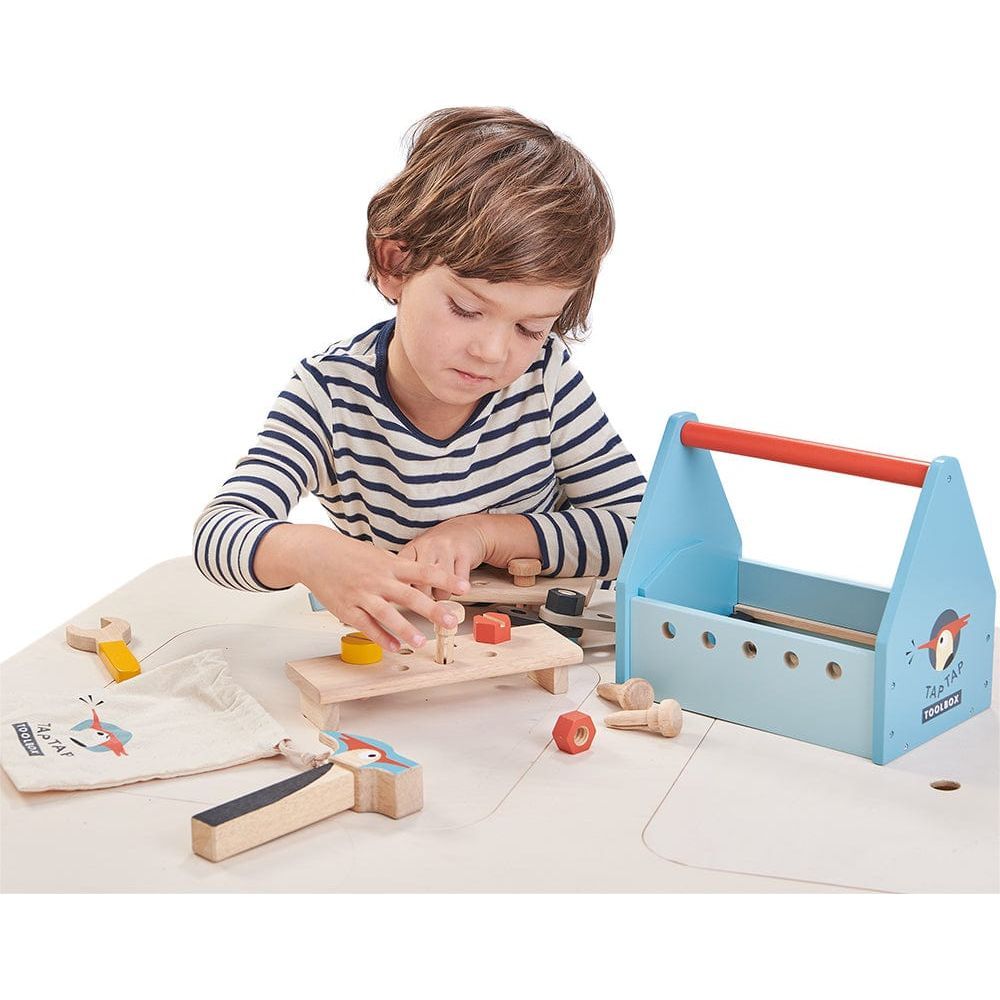 boy playing with Tender Leaf Tap Tap Wooden Tool Box