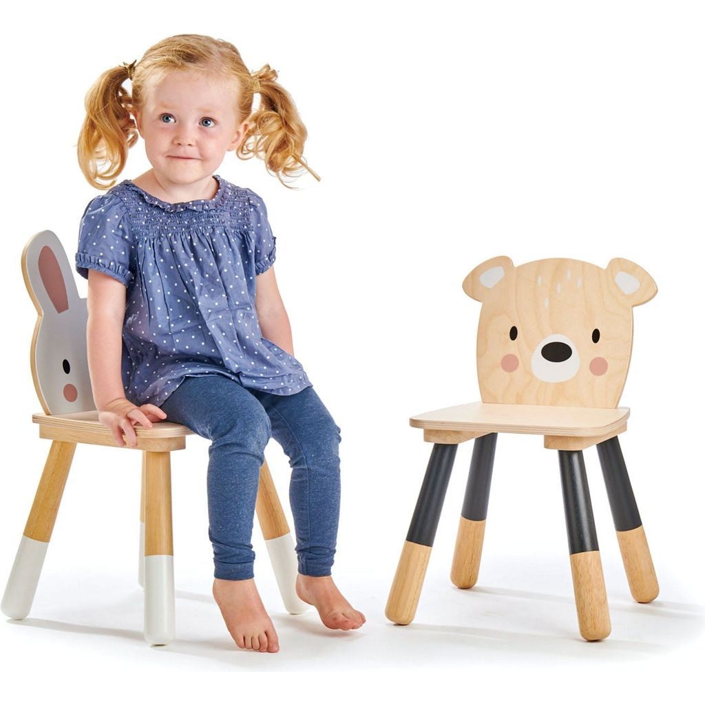 girl with pigtails sitting at Tender Leaf Kids Wooden Forest Table and Chairs Bundle
