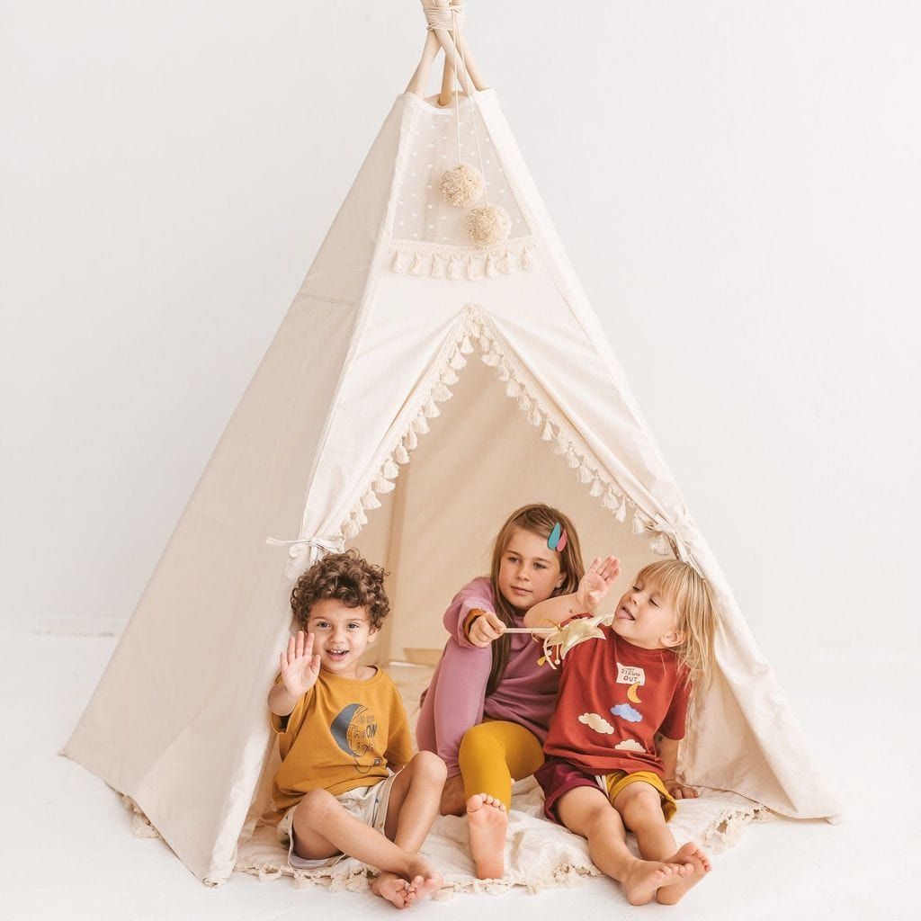 children sitting in MINICAMP Extra Large Indoor Teepee Tent With Tassels Decor in Boho Style