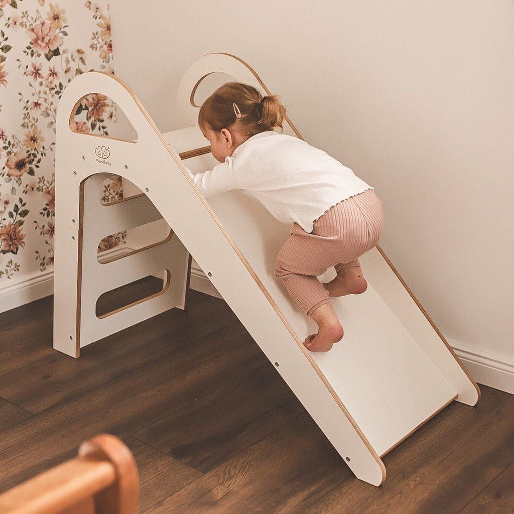 little girl climbing up Wooden Indoor Slide