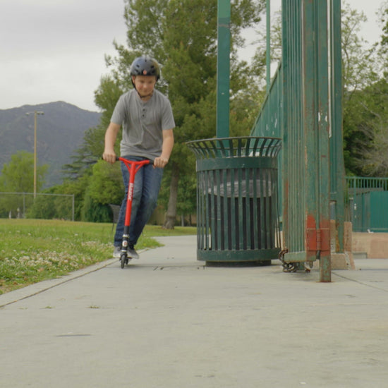 boy riding in skate park on Razor Beast V6 Scooter - Red