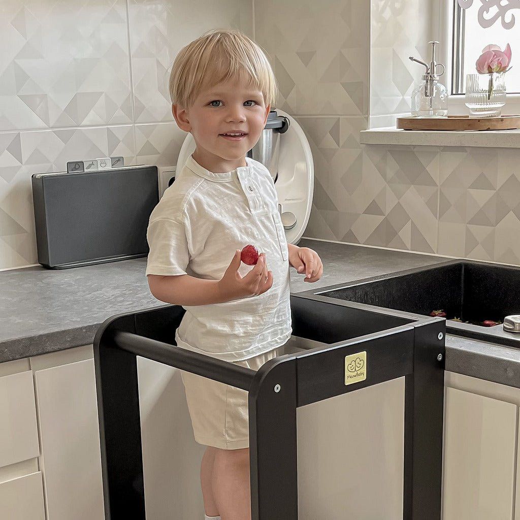 child standing on Wooden Kitchen Helper - Learning Tower - Black