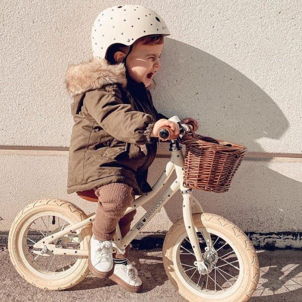Little boy wearing Banwood Helmet Bonton R Age 3-7 [50-54cm] in Matte Cream and riding Banwood Balance Bike
