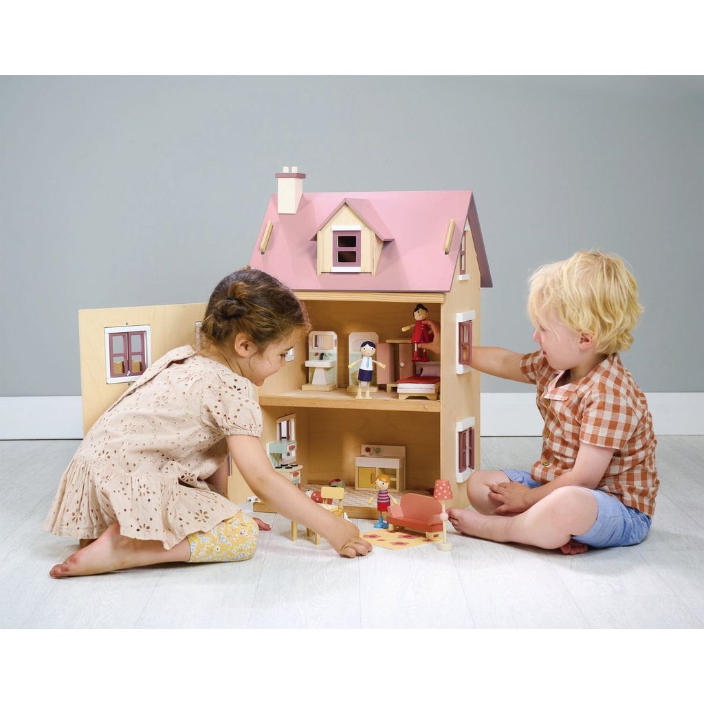 boy and girl playing with Tender Leaf Wooden Doll House Foxtail Villa + Furniture
