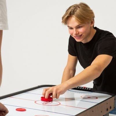boy playing on Gamesson Buzz Air Hockey Table 