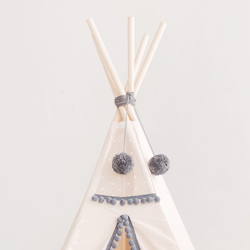 close up of MINICAMP Kids Teepee in Off-White With Grey PomPoms