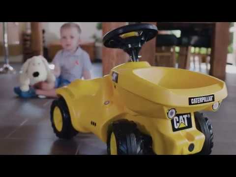video of boy playing with Rolly Toys Caterpillar Dumper Mini Trac With Tipping Dumper