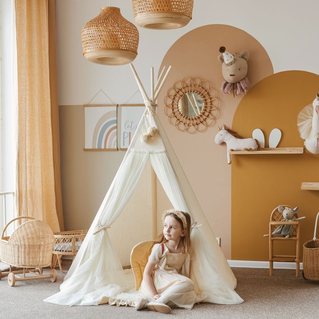 girl sitting in MINICAMP Fairy Kids Play Tent With Tulle in Ecru in lounge