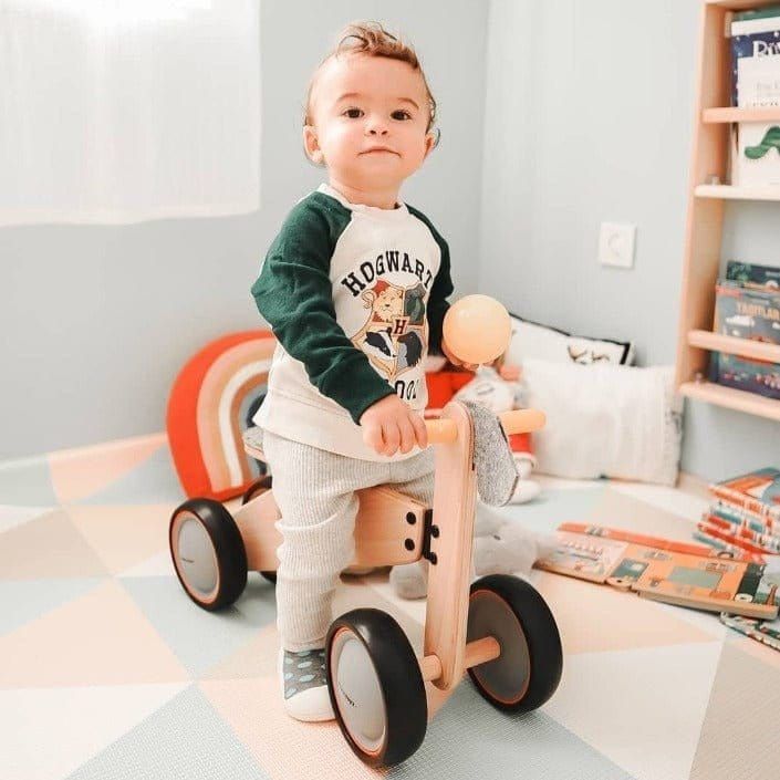 little boy riding Mama Toyz Wooden Mini Bike Age 15 Months + in playroom