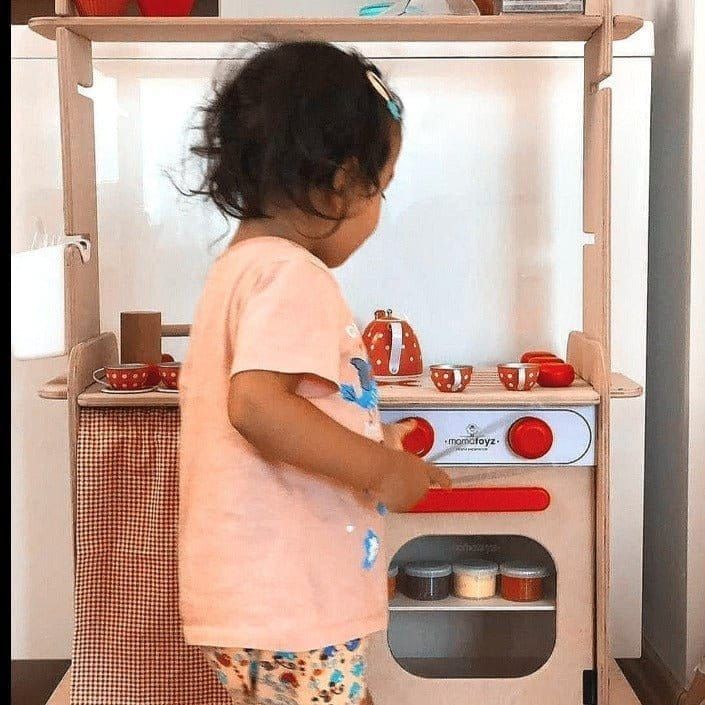 little girl playing with MamaToyz Sera Wooden Kitchen