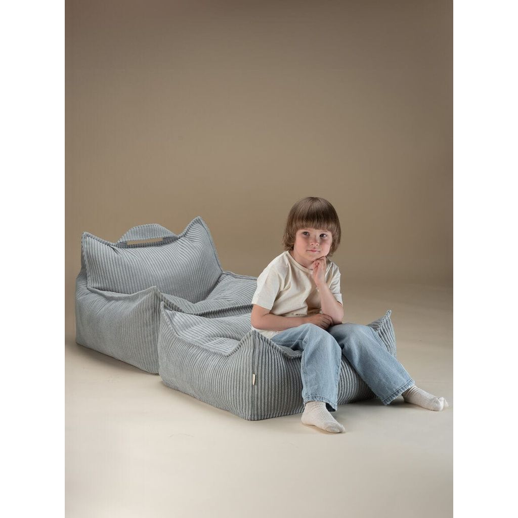 child sitting on Wigiwama Peppermint Green Square Ottoman with kids beanbag chair