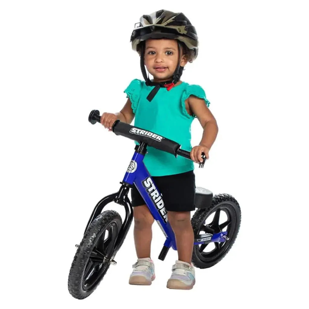 girl riding Strider Sport 12 inch Balance Bike - Blue